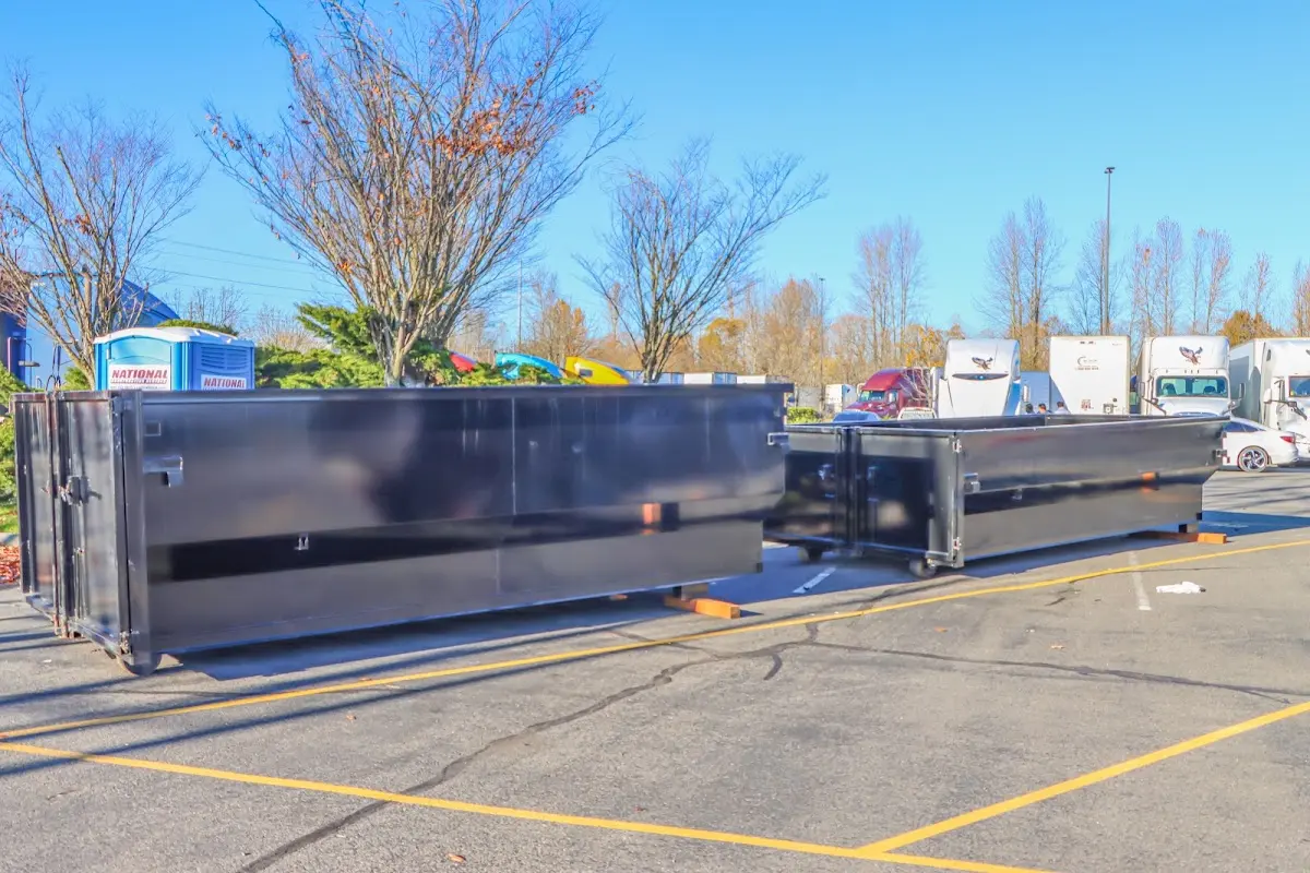 Professional dumpster rental service with roll-off container on residential driveway in Pleasantville